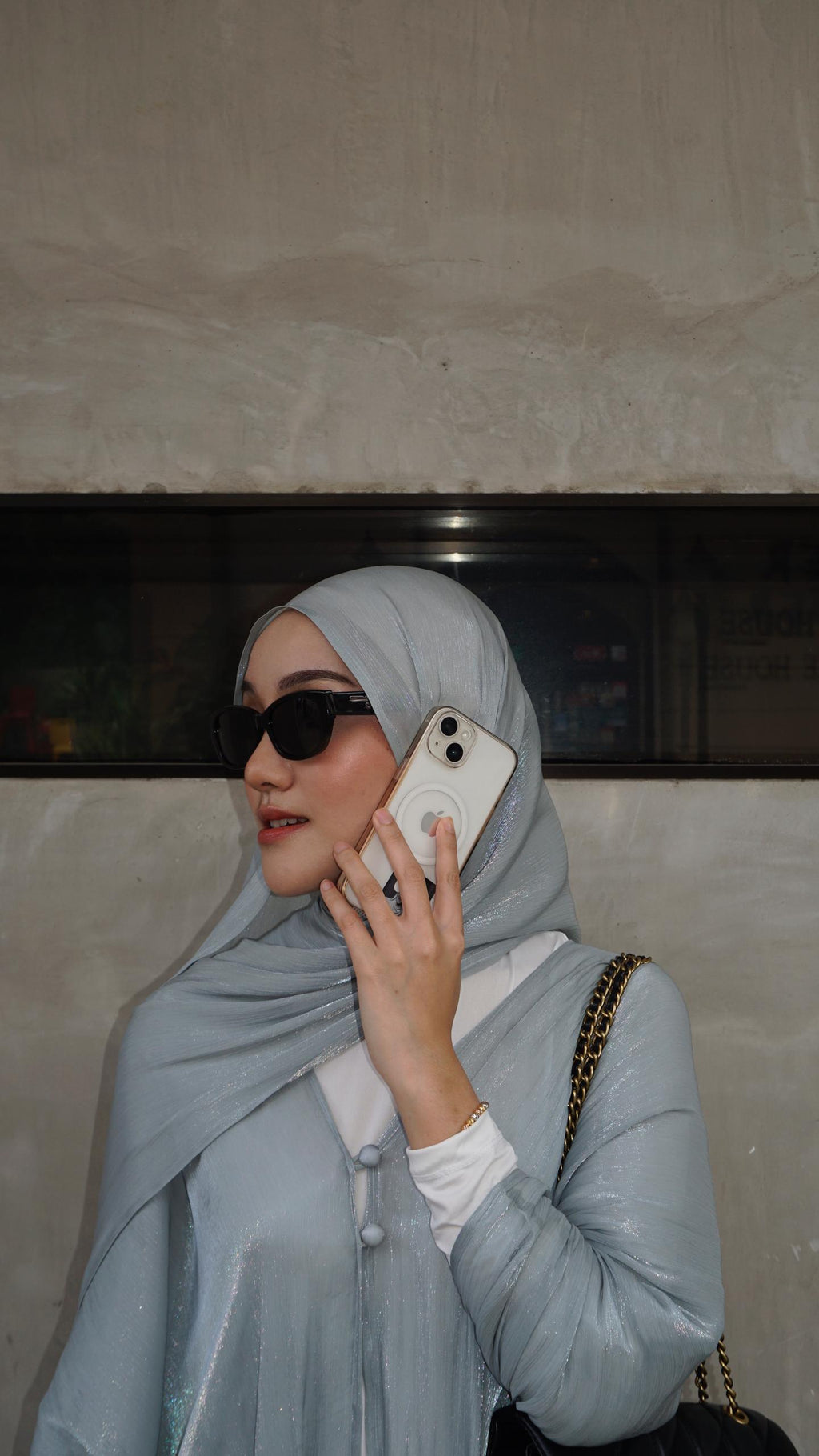 Women with hijab in stylish asian fitting sunglasses. A pair of square-shaped, green-tinted sunglasses with a full plastic frame.Womens Asian fitting Sunglasses. Ruby in Black - Black Lens 